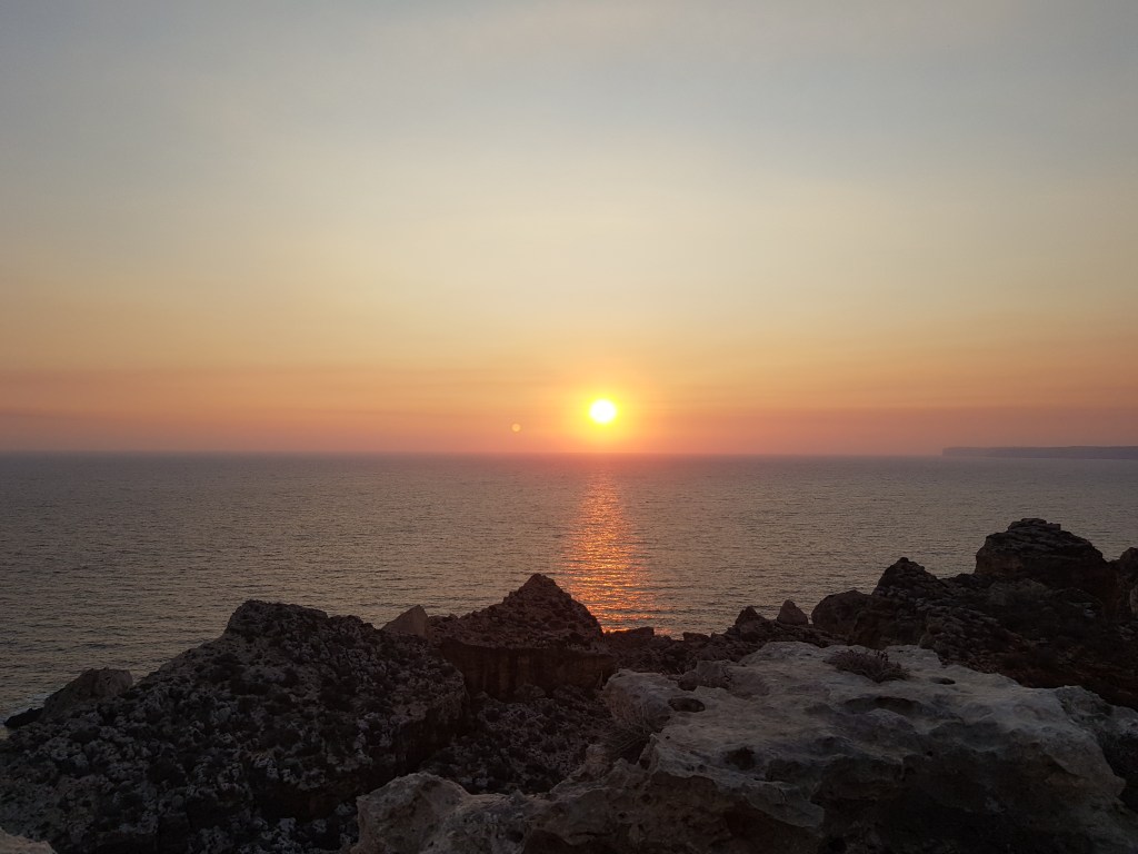 a photo of an August sunset off the southern coast of Malta
