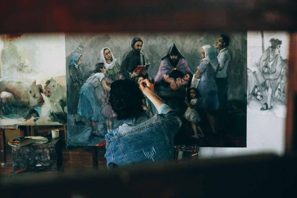 a photo of a painter at work from the back