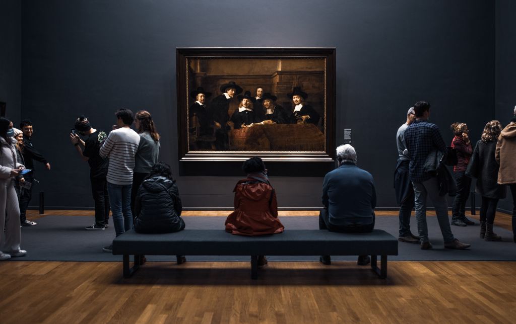 photo of tourists in Rijksmuseum in Amsterdam in front of a painting